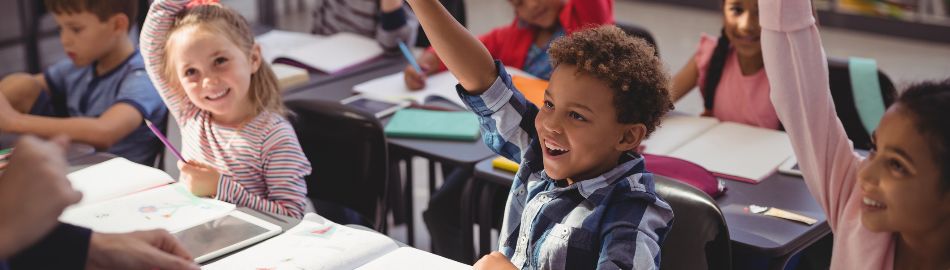 Children in a class raising their hands Children in a class raising their hands